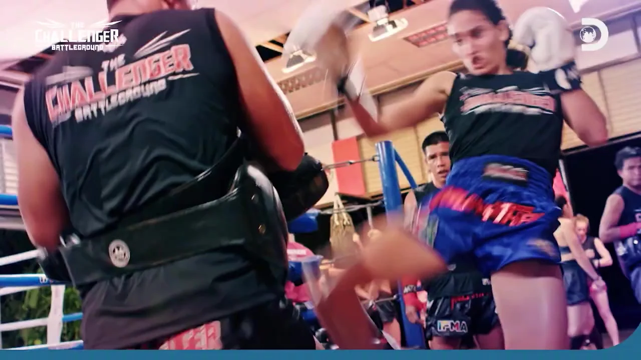 Two fighters clinched in the ring on The Challenger Battleground